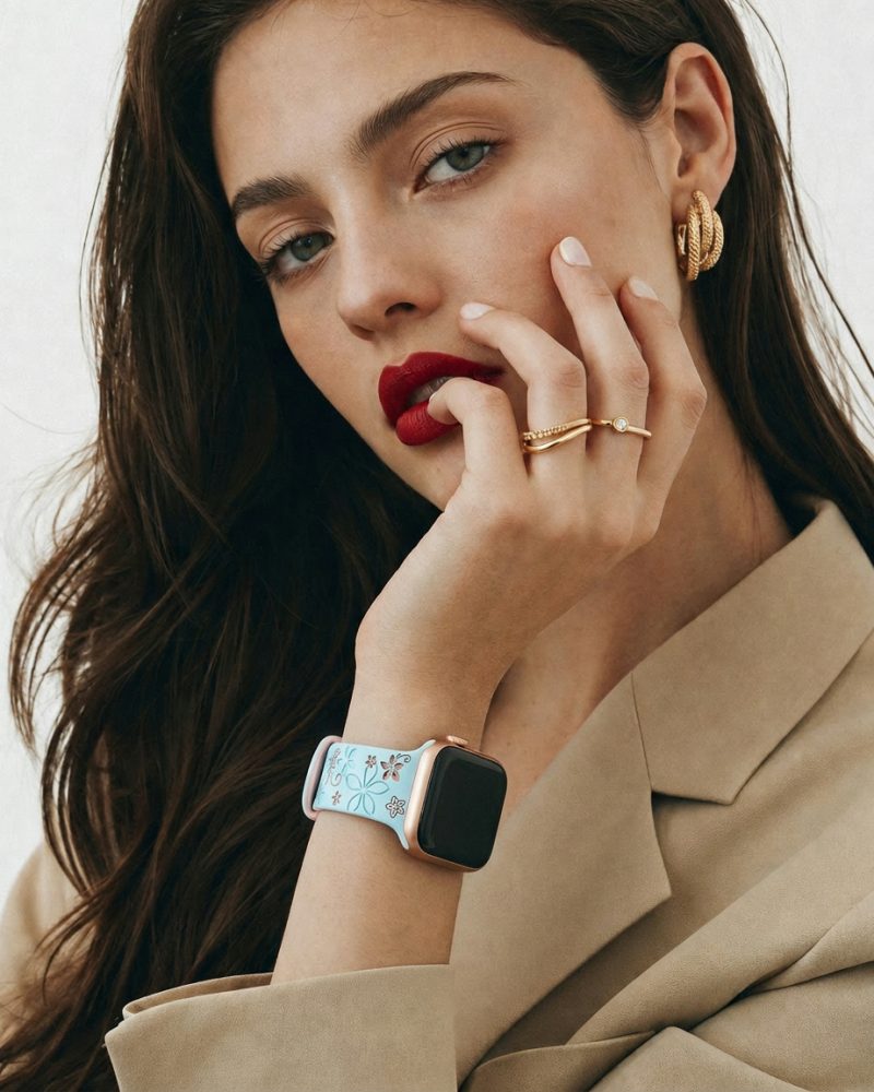 Woman wearing Sakura Sport Band light blue pink smartwatch with gold jewelry