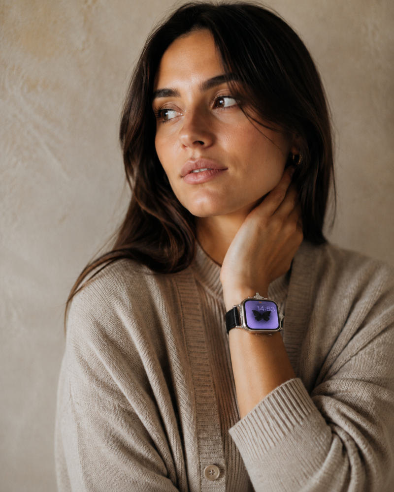 Woman wearing black leather strap smartwatch with purple display screen