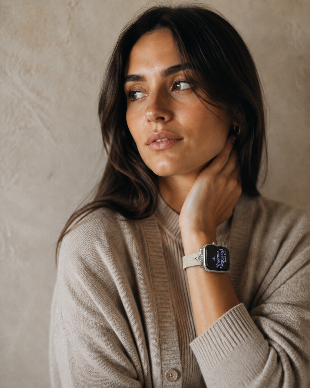 Woman wearing smartwatch with cappuccino leather strap and beige cardigan