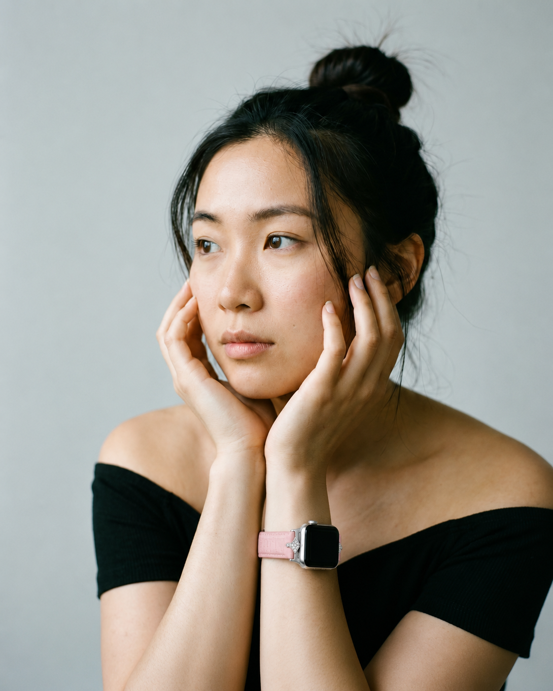 Woman wearing cherry blossom pink leather smartwatch strap on wrist