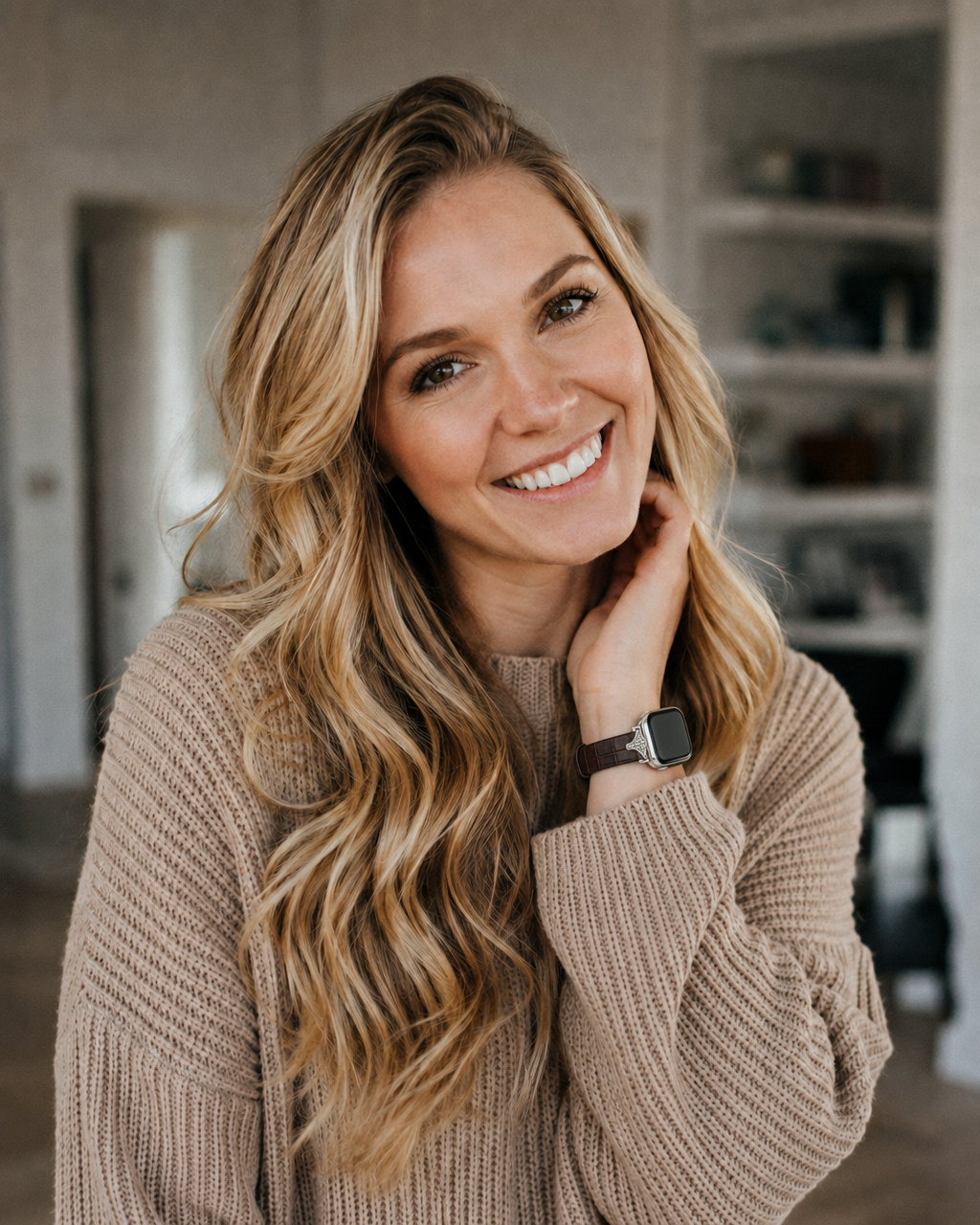 Woman wearing dark brown leather strap smartwatch with casual beige sweater