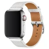 White leather Apple Watch band with tan leather interior and silver buckle