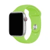 Silver smartwatch with bright green silicone sport band and red crown button